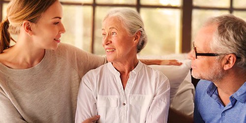 Younger woman sitting with an older woman and older man Younger woman sitting with an older woman and older man